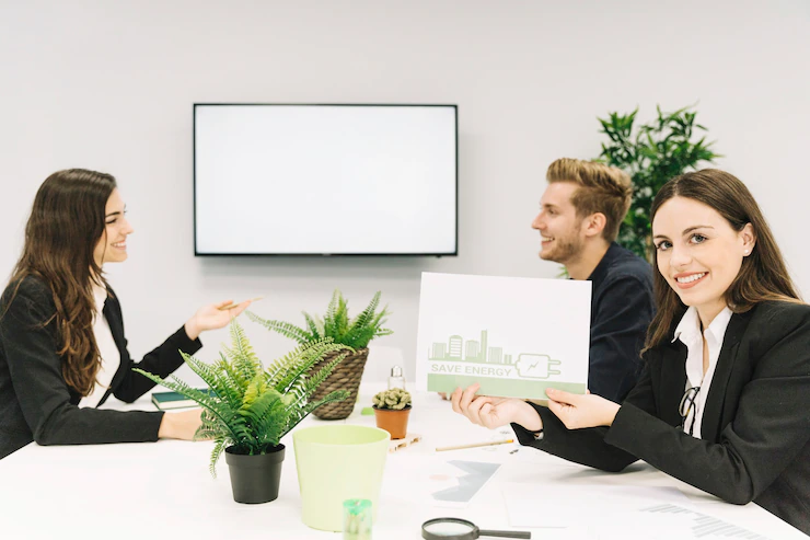 happy-woman-showing-energy-saving-concept-paper-office_23-2147826532
